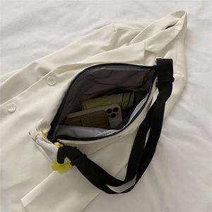 Spacious interior of beige nylon crossbody bag showing storage for phone and umbrella
