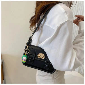 Black shoulder bag featuring cute dog embroidery and a colorful dinosaur charm