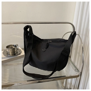 Macro shot of durable black nylon half-moon bag with adjustable wide fabric strap