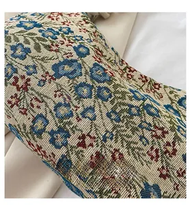 Macro detail of vintage floral jacquard fabric with blue flowers on a canvas shoulder bag