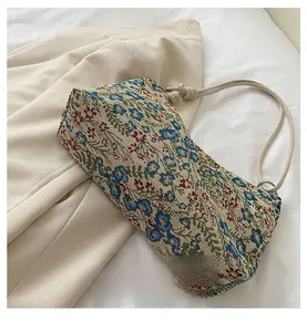 Close-up of vintage floral jacquard fabric with woven knot handles and metal rings