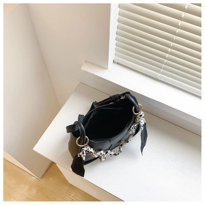 Overhead view of black bucket bag showing spacious interior and animal print silk scarf detail