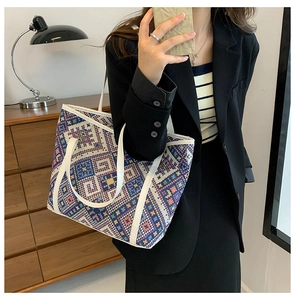 Detail view of large canvas tote bag with colorful geometric patterns on black blazer