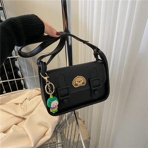 Fashionable black crossbody bag with cartoon dog patch and dinosaur doll pendant