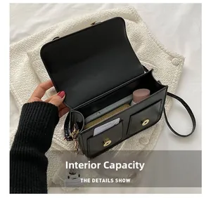 Detail view showing internal storage capacity of the black PU leather crossbody bag