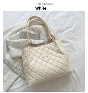 Détails du motif matelassé sur le grand sac cabas en similicuir blanc crème