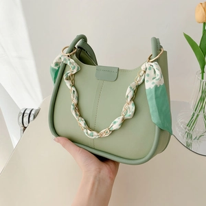 Fashionable light green half-moon bucket bag with gold chain and floral scarf detail