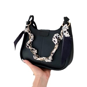 Chic black crescent shoulder bag with cow print scarf and gold chain strap detail