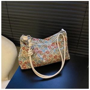 Detailed view of floral jacquard fabric texture and zipper closure on the hobo bag