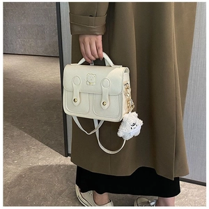 Chic beige PU leather crossbody bag with cute bear pattern and plush bear charm detail