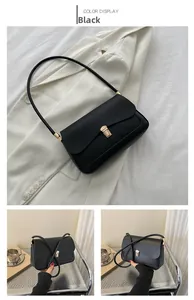 Detailed view of a black retro saddle bag featuring a rectangular gold metal buckle
