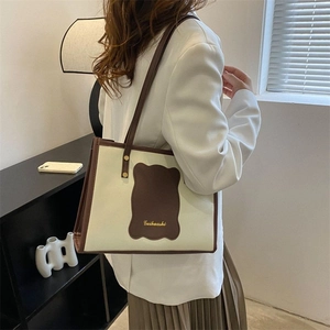 Detail of minimalist tote bag with contrast piping and wave pattern in a lifestyle setting