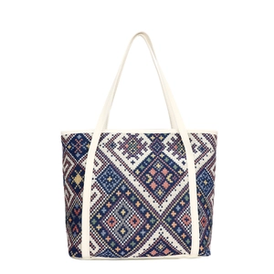 Large ethnic geometric woven canvas tote bag with cream leather handles and colorful patterns