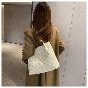 Vue détaillée du sac cabas matelassé blanc avec surpiqûres en losanges et texture soignée