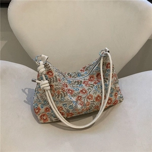 Vintage floral jacquard shoulder bag with intricate flower patterns and knotted strap