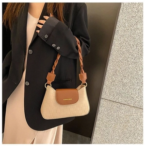 Detail of checkered shoulder bag featuring a woven braided strap and golden hardware