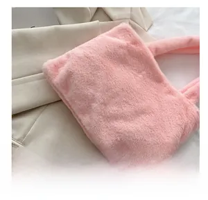 Close-up of the rectangular bottom construction on a pink plush tote bag