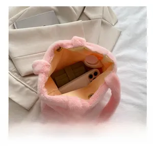 Pink plush tote bag interior showing capacity for phone, wallet and cosmetics
