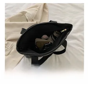 Internal view of large capacity quilted tote bag showing umbrella and daily items