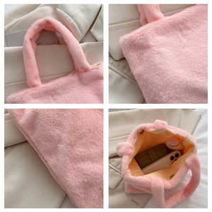 Detail of pink plush handbag showing soft faux fur texture and spacious interior lining