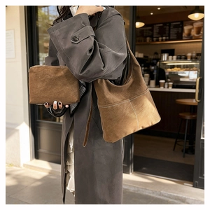 Detail of vintage brown suede tote set with large shoulder bag and small clutch