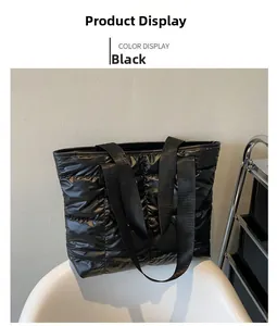 Detail of black quilted down tote bag with diamond texture on a white chair