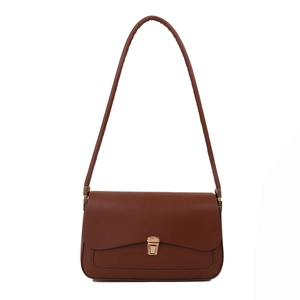 Classic brown vintage saddle shoulder bag with minimalist flap and gold metal buckle