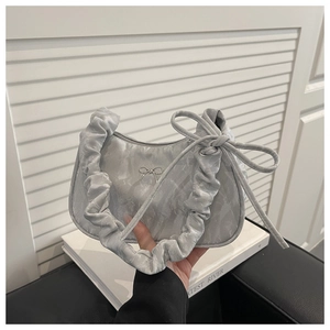 Nahaufnahme einer silbergrauen Handtasche mit Seidentextur und eleganten Schleifendetails