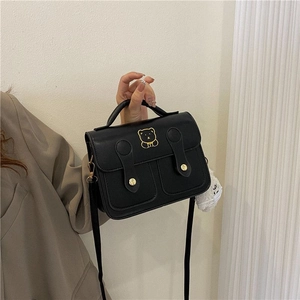 Retro black PU leather crossbody bag with golden bear logo and white plush charm