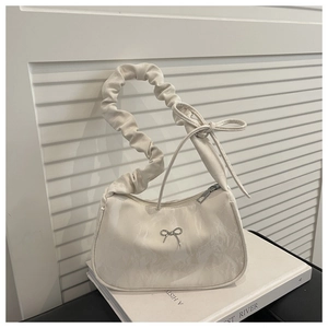 Detail of off-white butterfly shoulder bag with marble texture and pleated handle
