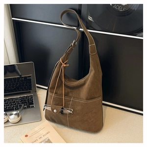 Detail of coffee brown matte tote bag with contrast stitching and glasses pouch pendant