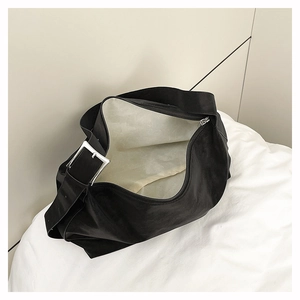Detail view of large black tote bag interior with zipper opening and silver buckle