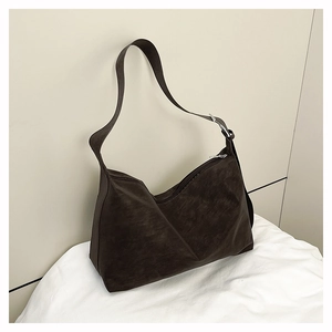 Close-up of deep coffee matte tote bag with wide shoulder strap and silver metal buckle