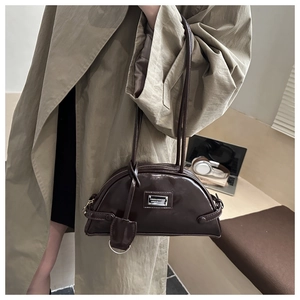 Detail view of smooth dark brown crescent shoulder bag with metallic logo and dual straps