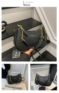 Close-up of black ostrich pattern hobo bag with gold chain and metal logo detail