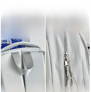 Detail of backpack showing breathable mesh handle and dual smooth zippers with woven pulls