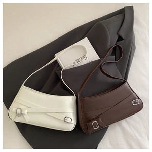 Detail of minimalist leather shoulder bags with crossbody straps and buckle decorations