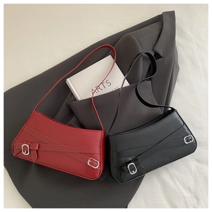 Detailed close-up of retro baguette bags in black and dark red matte leather with silver buckles
