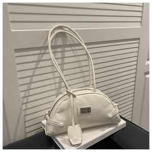 Detailed close-up of a cream-white half-moon shoulder bag with glossy finish and metal logo