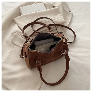 Internal view of brown frosted Boston bag showing capacity for wallet and cosmetics