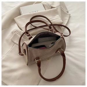 Internal capacity of khaki Boston bag showing phone, wallet and cosmetics inside
