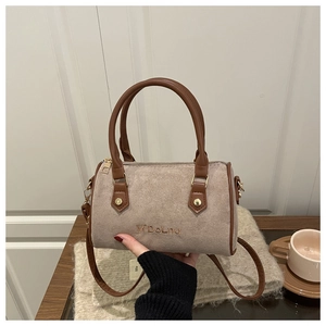 Close-up of retro Boston bag with suede fabric and embroidery in a cozy setting