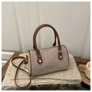 Detail of Boston handbag in beige suede with brown faux leather straps and metal zipper