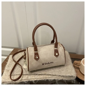 Detail of beige suede Boston bag featuring M'DoLnu embroidery and brown leather straps