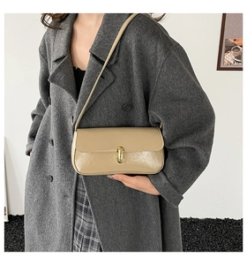 Detail of a beige PU leather shoulder bag featuring a stylish gold metal buckle lock