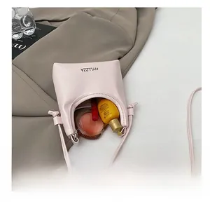 Top view of compact pink crossbody bag showing interior space for lipstick and cosmetics