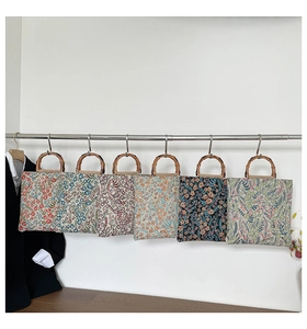 Detail of floral canvas tote bags featuring authentic natural bamboo handles for women