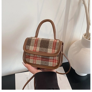 Detail of vintage mini plaid handbag with tweed fabric and brown faux leather trim
