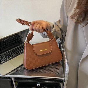 Brown faux leather crossbody bag with checkered texture and woven top handle