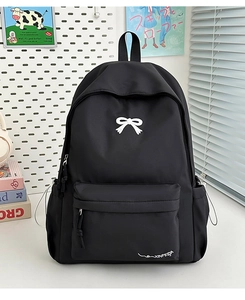 Minimalist black backpack featuring a white bow detail and side water bottle pocket